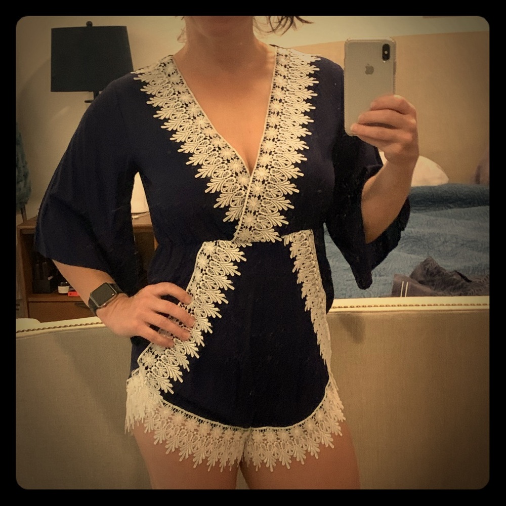 Navy blue romper with white lace trim.